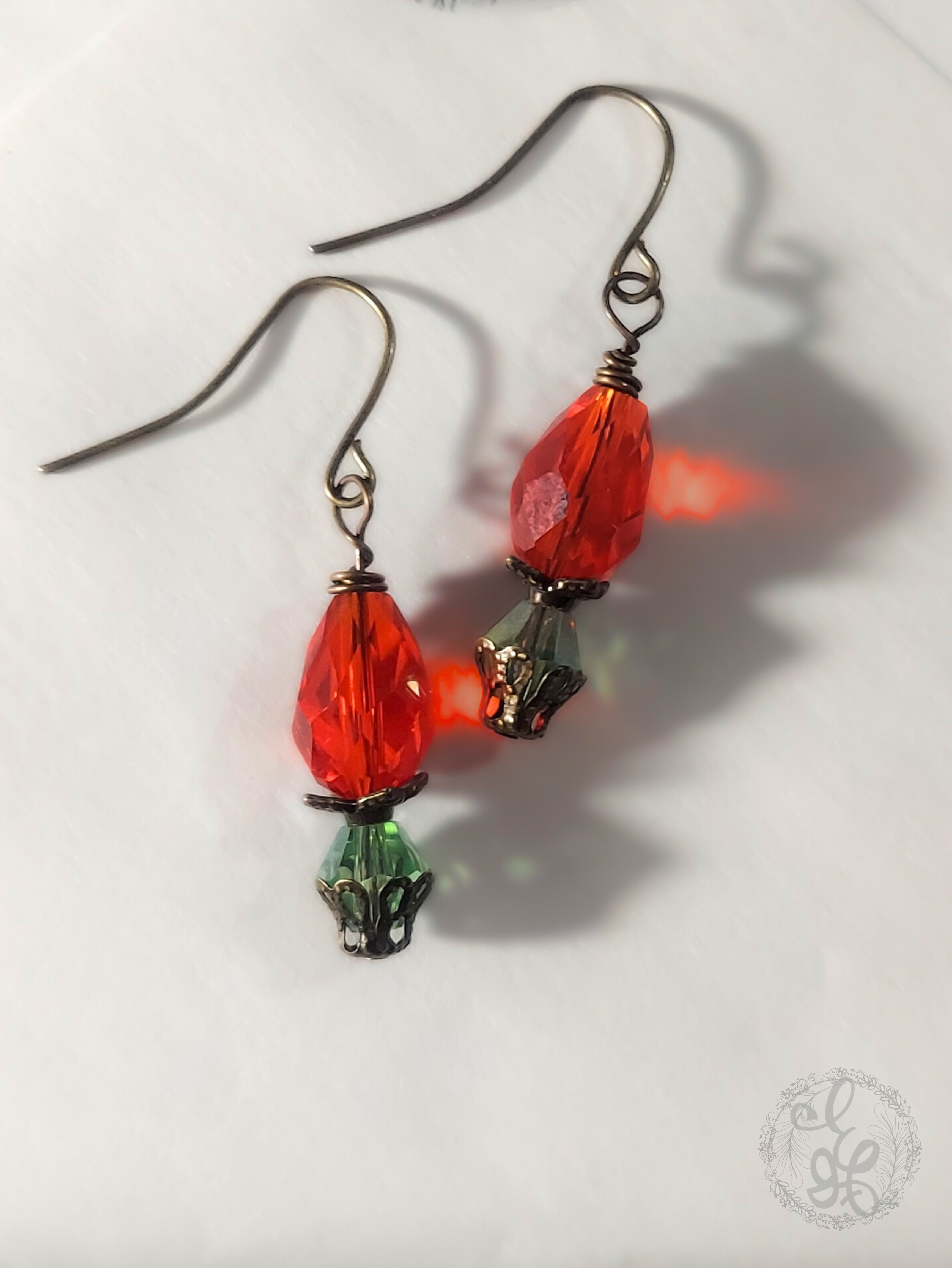 Red Rosebud Crystal Dangle Earrings in Antique Brass