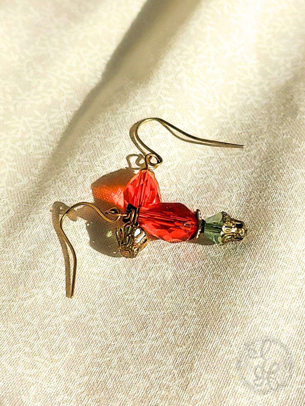 Red Rosebud Crystal Dangle Earrings in Antique Brass