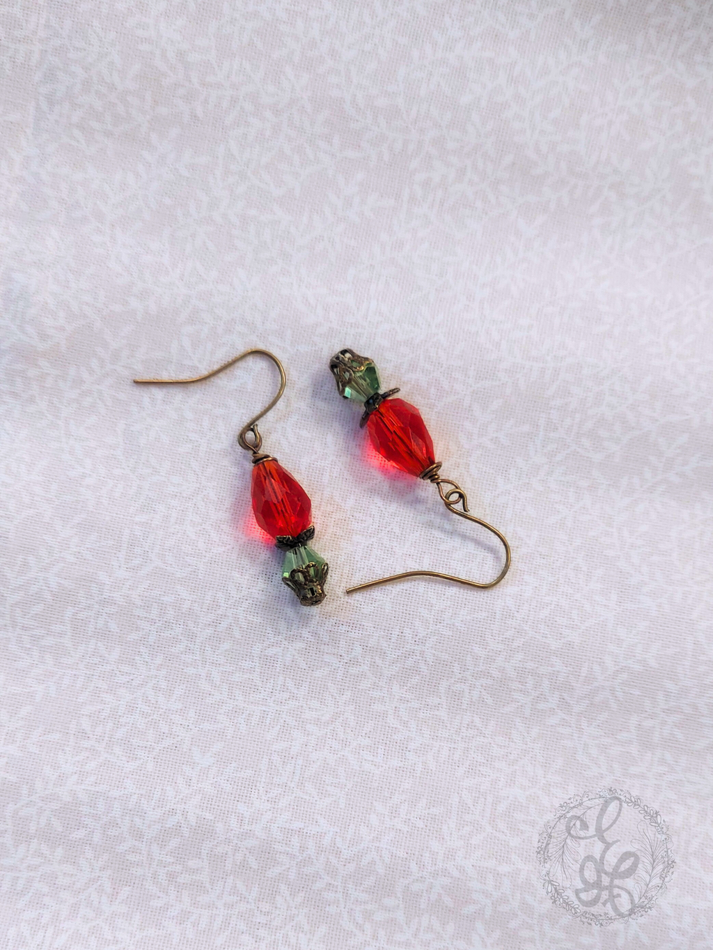 Red Rosebud Crystal Dangle Earrings in Antique Brass