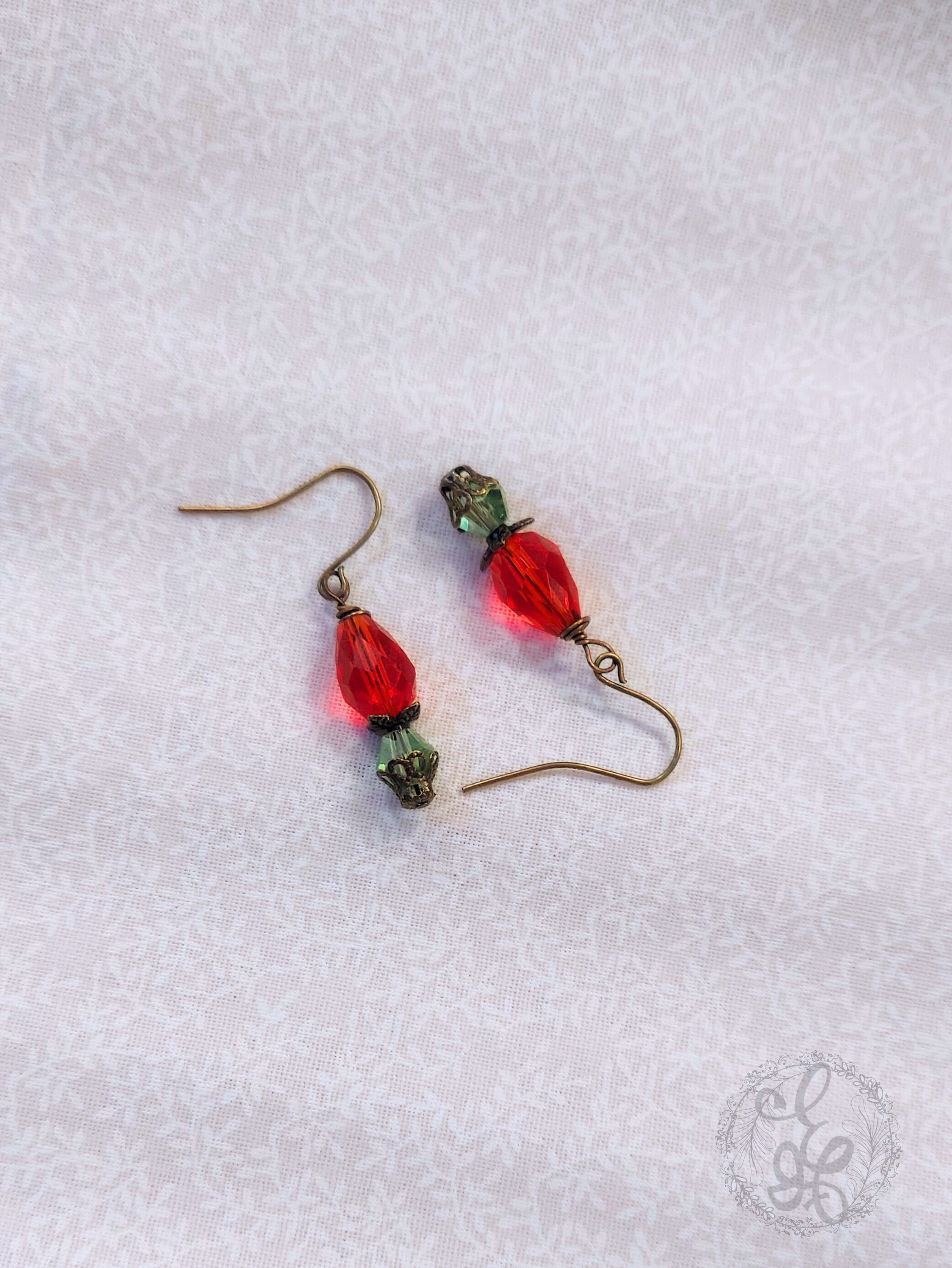 Red Rosebud Crystal Dangle Earrings in Antique Brass