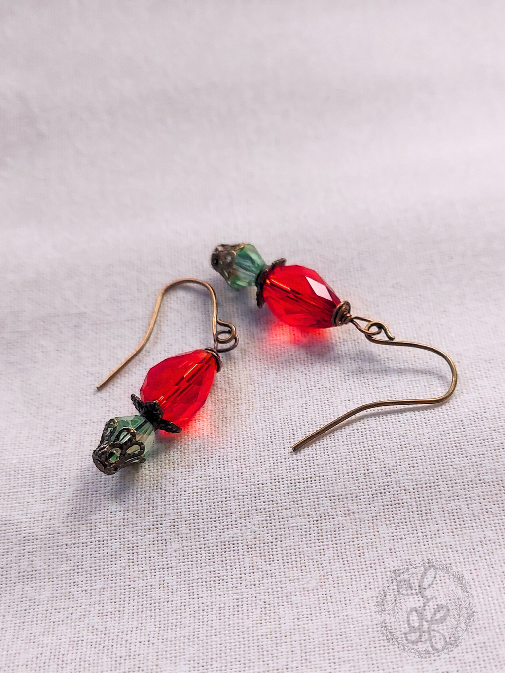 Red Rosebud Crystal Dangle Earrings in Antique Brass