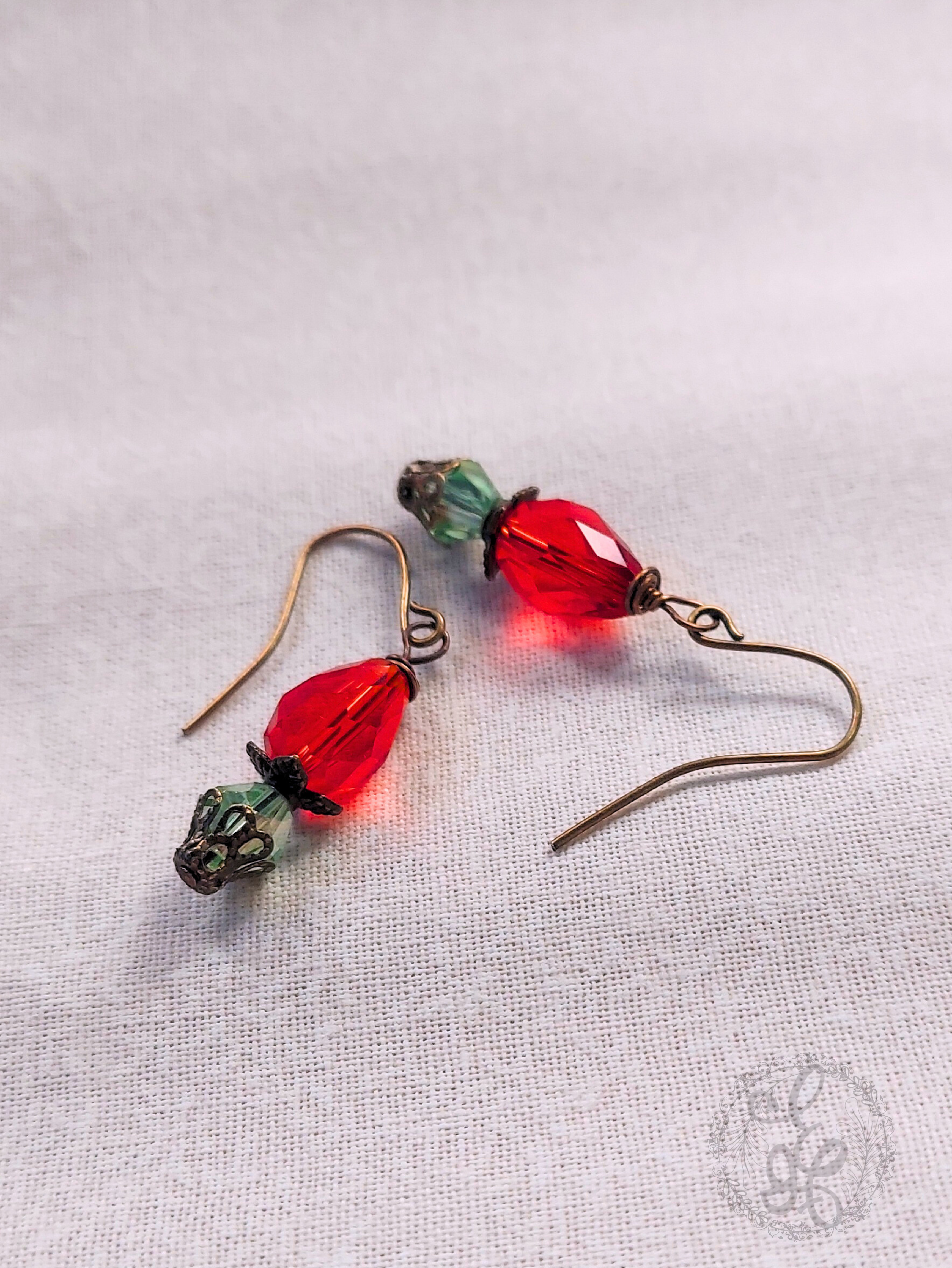 Red Rosebud Crystal Dangle Earrings in Antique Brass