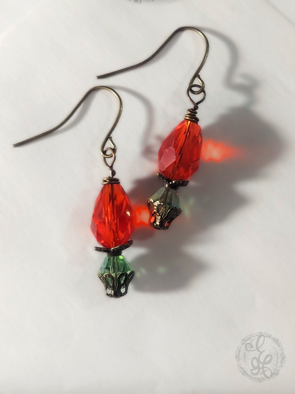 Red Rosebud Crystal Dangle Earrings in Antique Brass