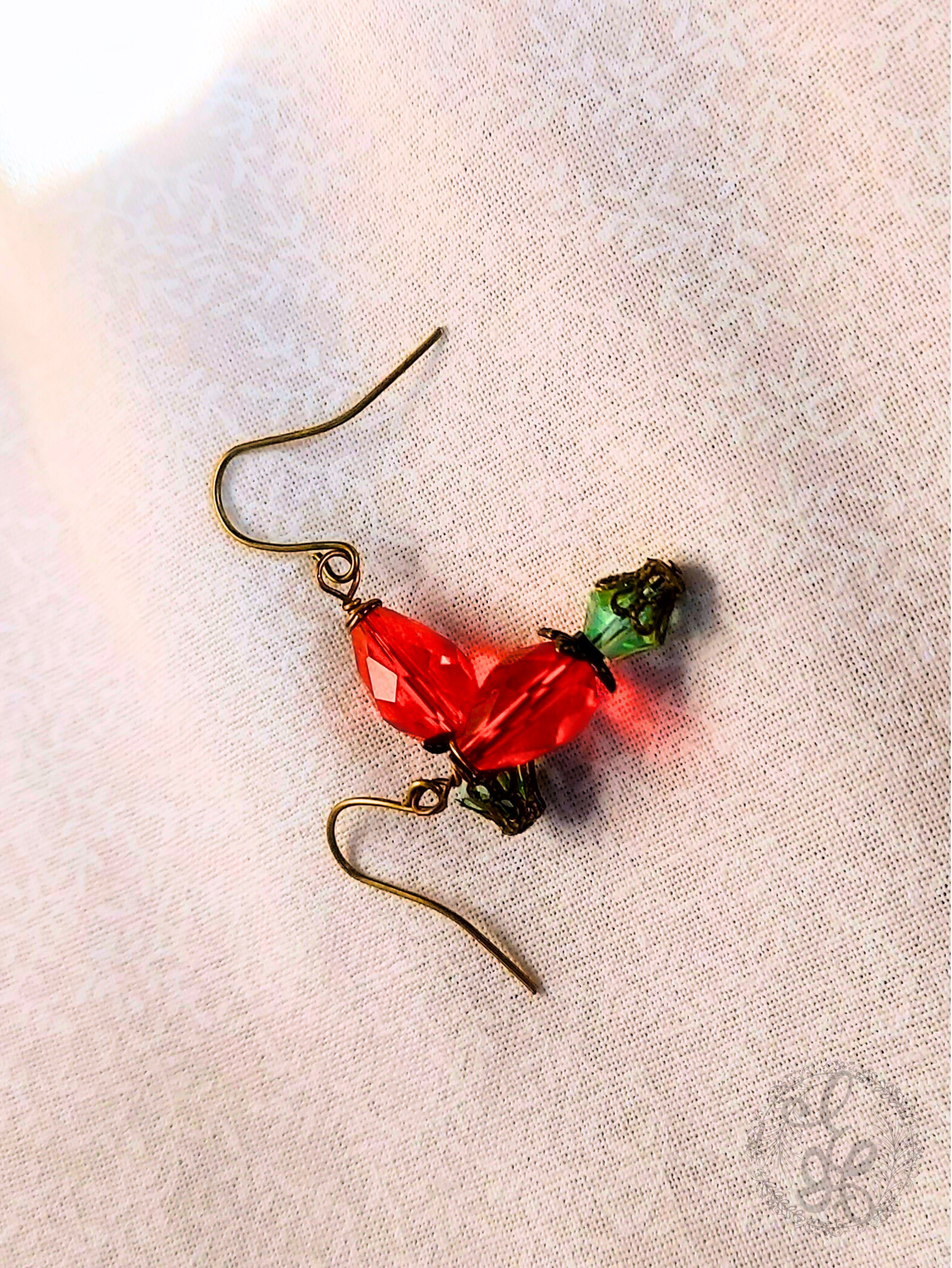 Red Rosebud Crystal Dangle Earrings in Antique Brass